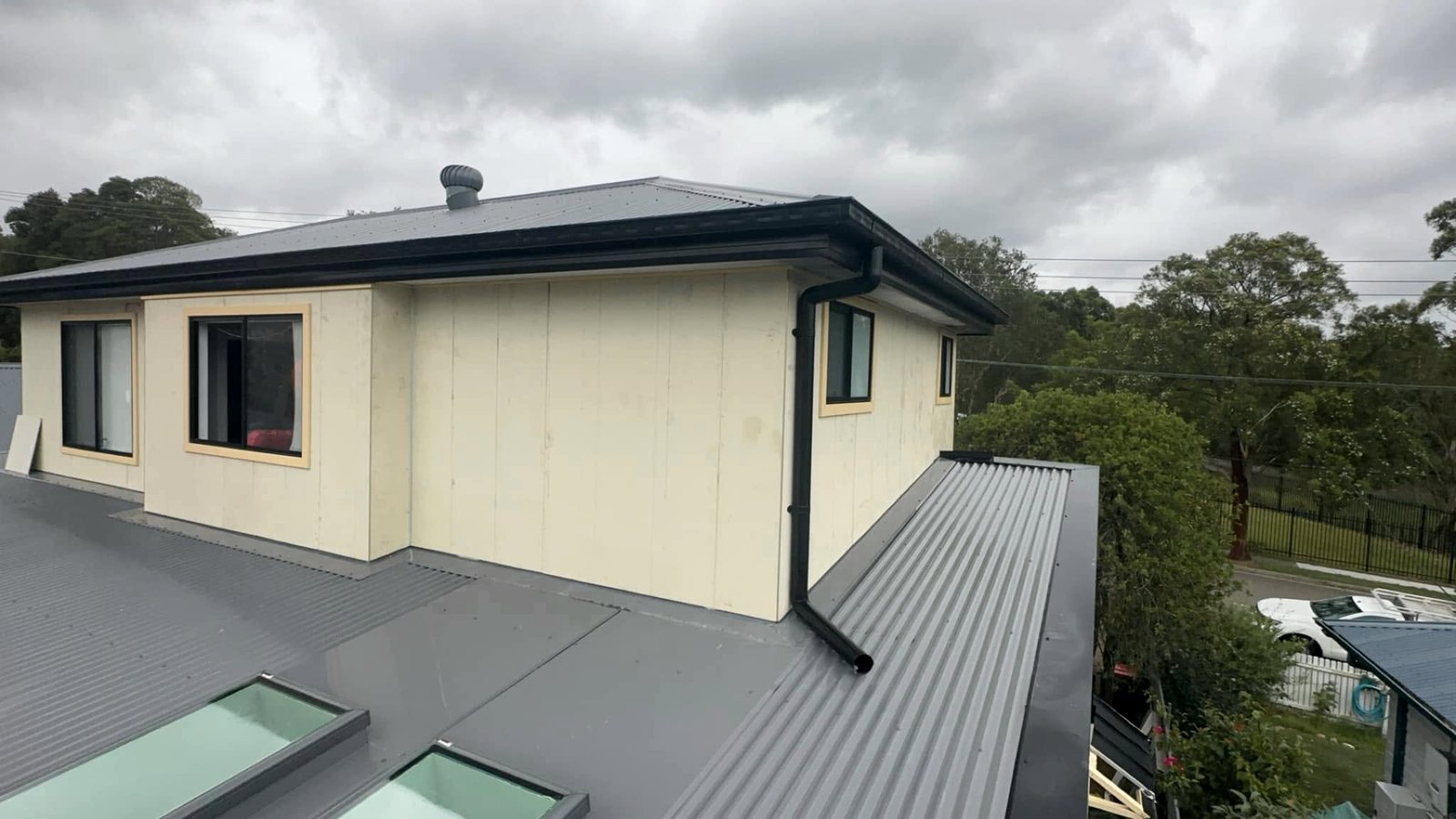 After: new cladding and black windows